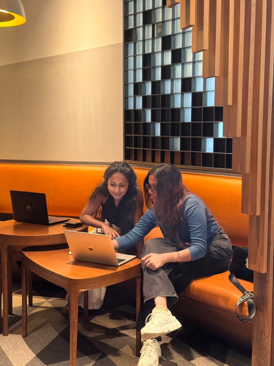 Team member working at a table with a laptop